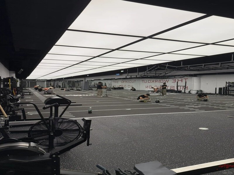 A close-up of different infill materials like black SBR rubber and beige TPE granules